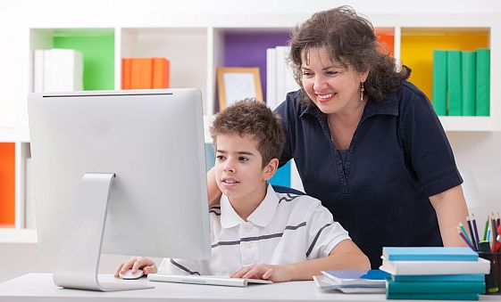 woman using computer with son